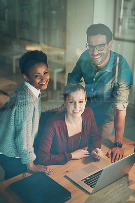 Buy stock photo High angle portrait of three young businesspeople looking at a laptop