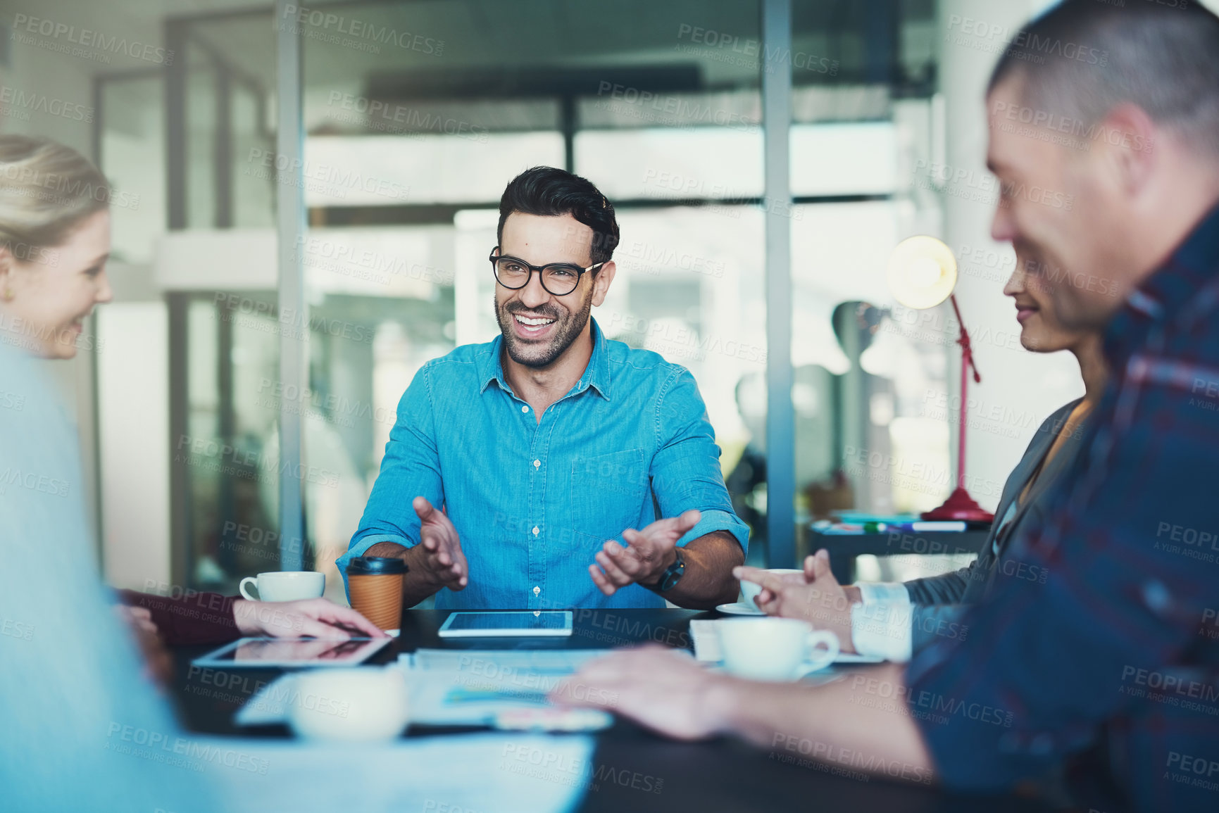 Buy stock photo Cropped shot of a group of businesspeople meeting in the boardroom