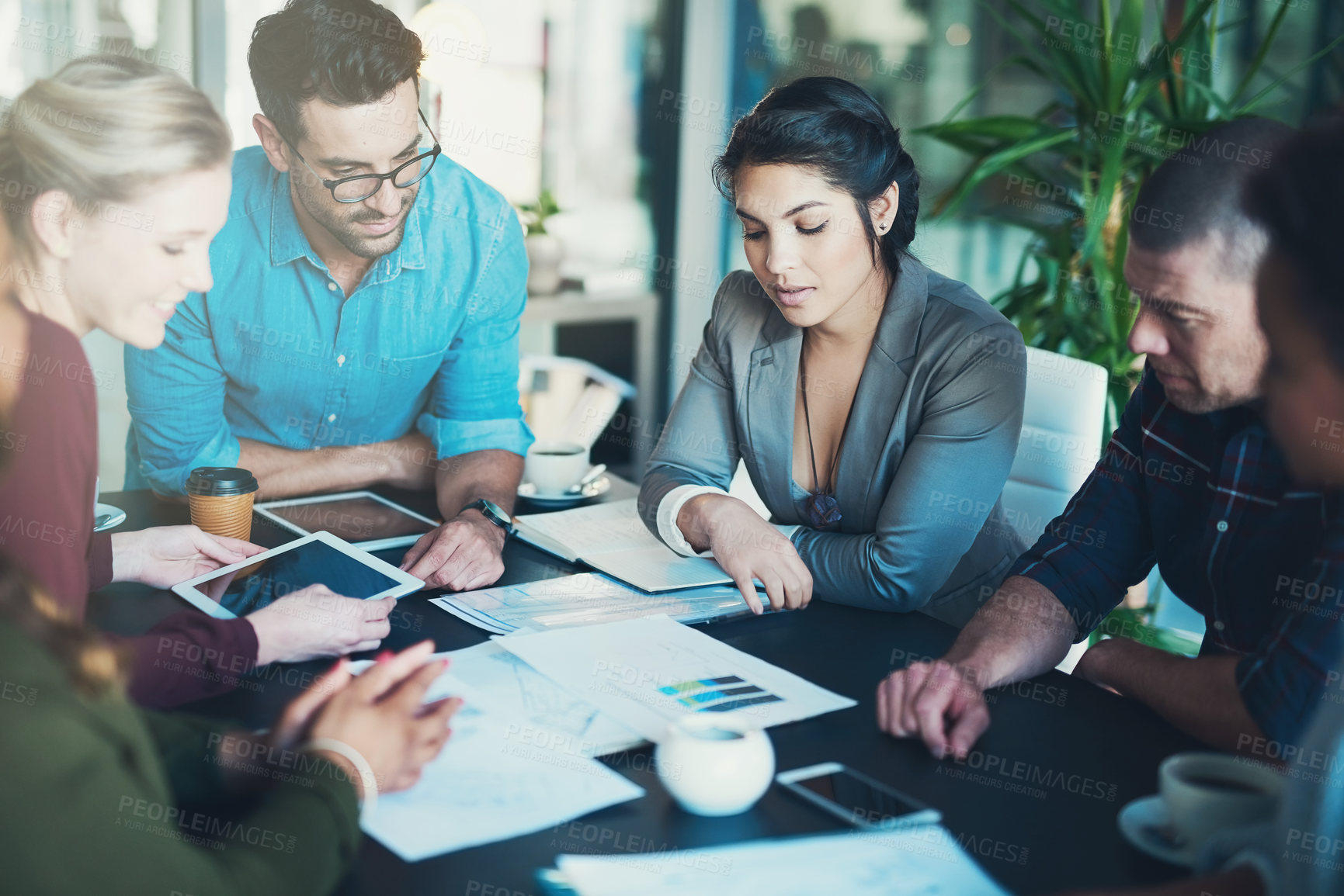 Buy stock photo High angle shot of a group of businesspeople meeting in the boardroom