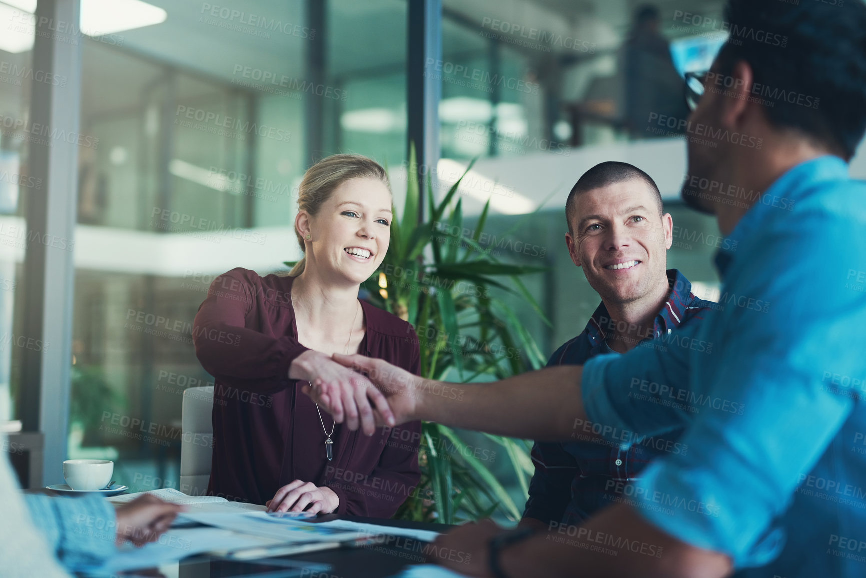 Buy stock photo Cropped shot of two businesspeople shaking hands during a meeting