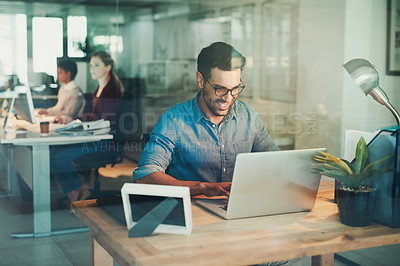 Buy stock photo Cropped shot of a businessman working on his laptop in the office