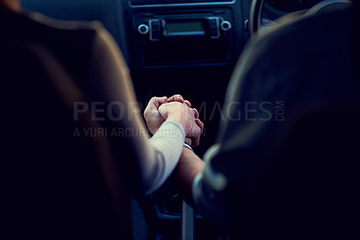 Buy stock photo Rearview shot of a unrecognizable couple holding hands while driving in a car