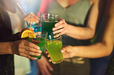Buy stock photo Cropped shot of a group of women toasting with cocktails at a party