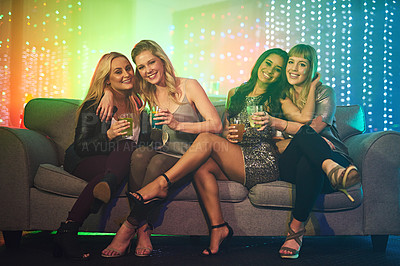 Buy stock photo Shot of a group of friends having drinks on a sofa at a party