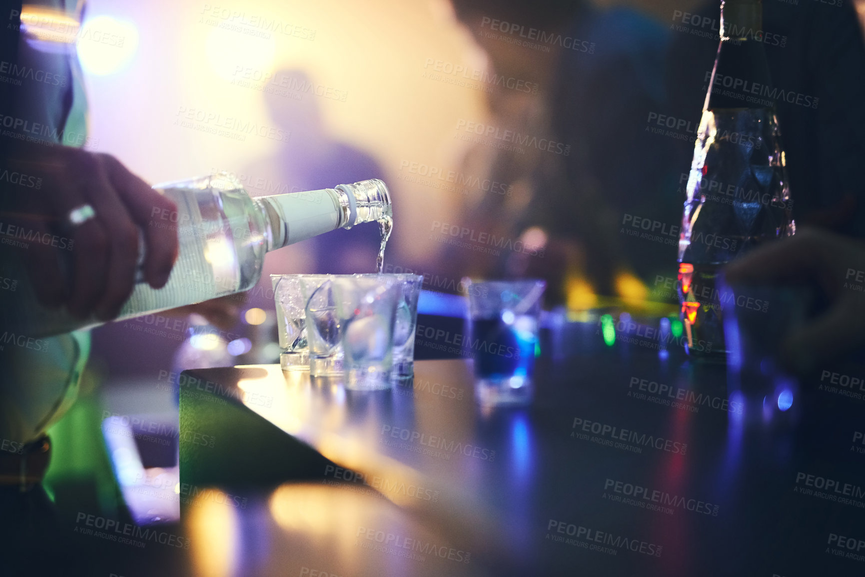 Buy stock photo Barman, spirits and pour alcohol in night club for service, order and counter server with hospitality. Bartender, employee and prepare drink in glass at social event, happy hour and serving liquor