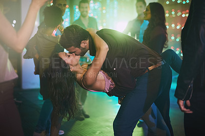 Buy stock photo Dance, kiss and couple in club at night on date with love in marriage or relationship. People, hug and romantic embrace together at neon disco, party or rave at techno music festival in lights