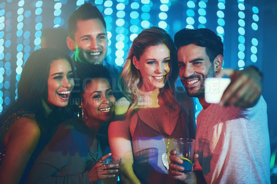 Buy stock photo Shot of a group of friends posing for a selfie together in a nightclub