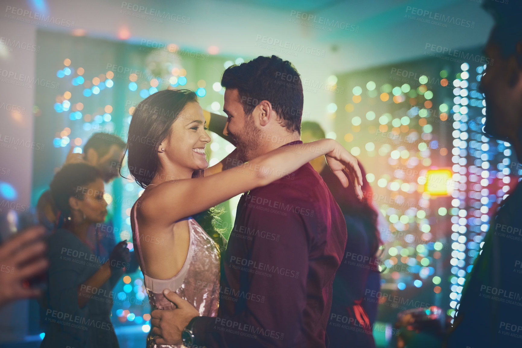 Buy stock photo Couple, hug and dance in club at night on date with love in marriage or relationship. People, celebrate and embrace together with happiness at neon disco, party or rave at techno music festival