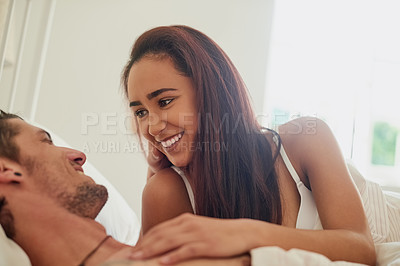 Buy stock photo Shot of an affectionate young couple in their bedroom in the morning