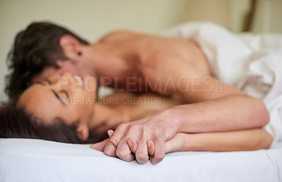 Buy stock photo Shot of an affectionate young couple making love in their bedroom in the morning