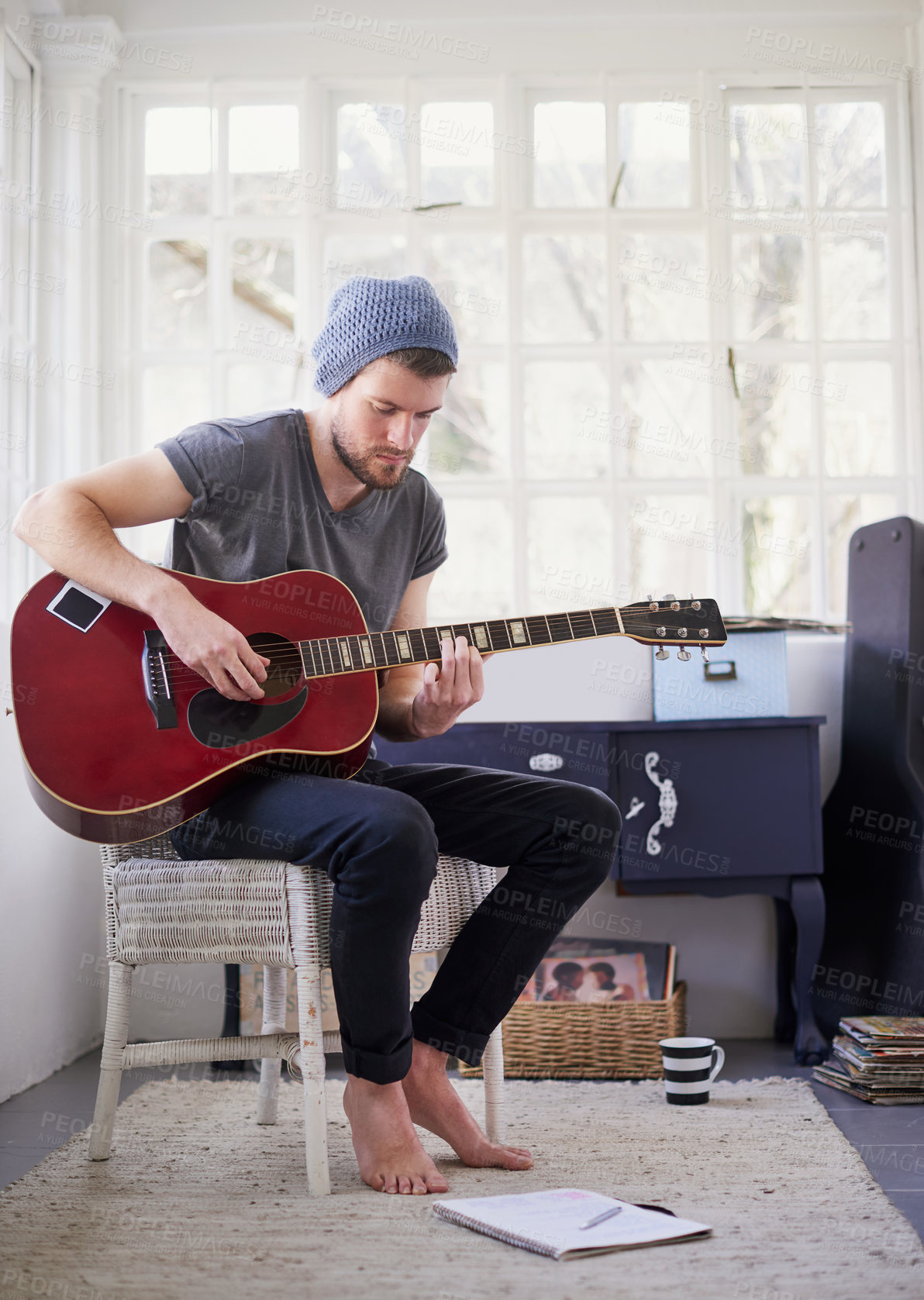 Buy stock photo Man, guitar and jazz music in home for practice, talent and learning with notebook in bedroom. Male person, musician and acoustic instrument for performance or practice in apartment for creativity