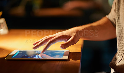 Buy stock photo Cropped shot of a man using his digital tablet