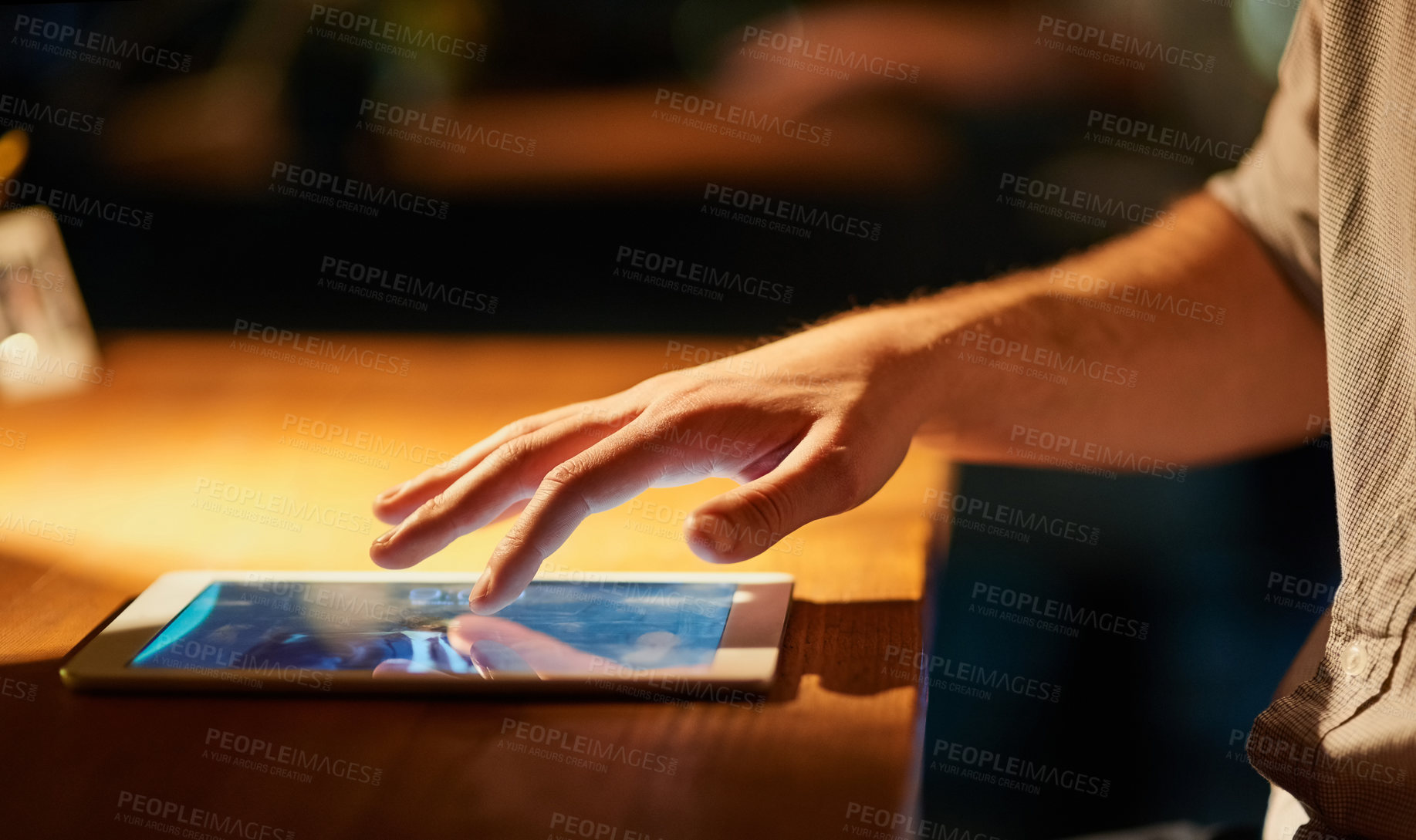 Buy stock photo Cropped shot of a man using his digital tablet