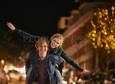 Buy stock photo Shot of a young couple out on a date in the city