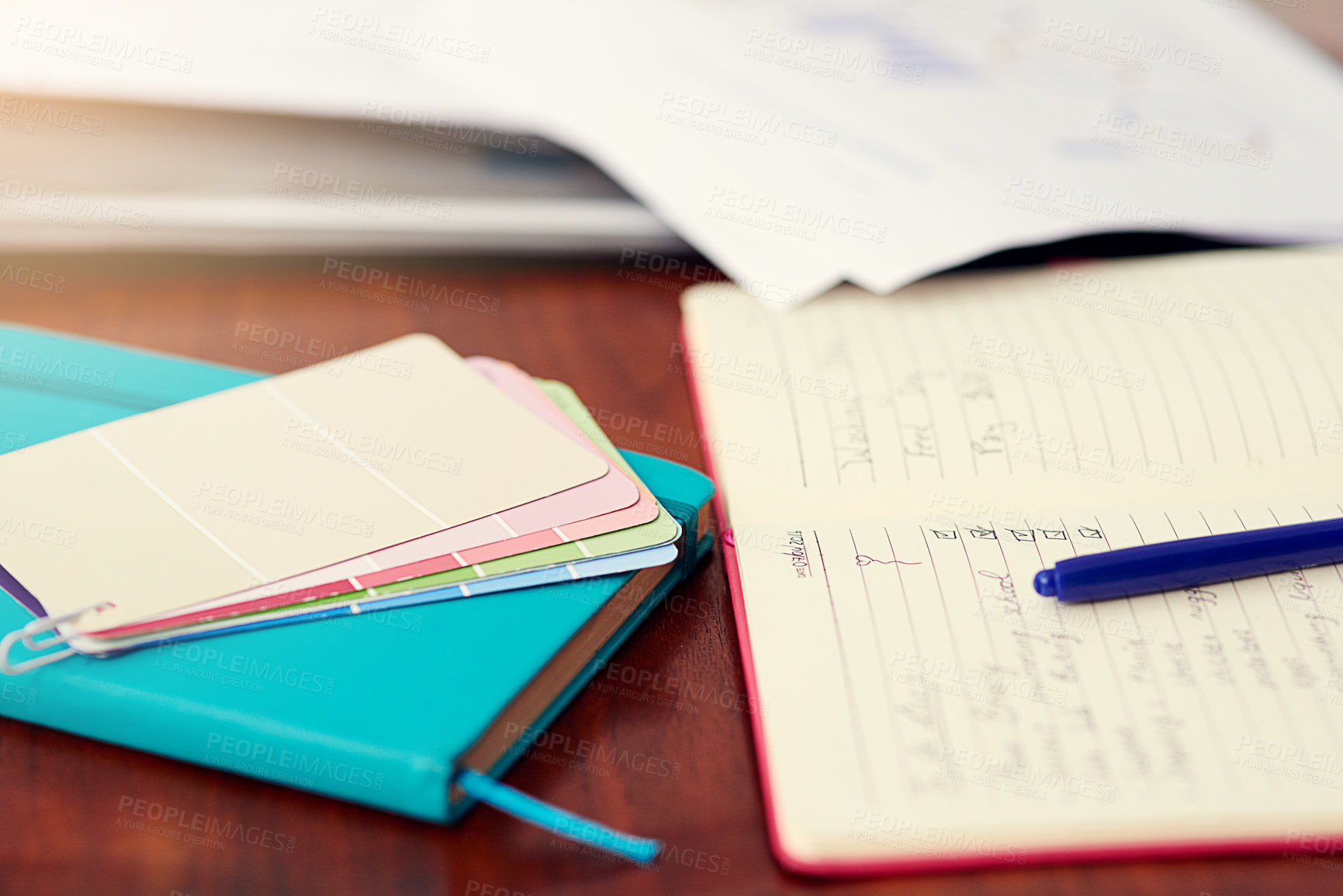 Buy stock photo Shot of color swatches and an open notebook on an office desk