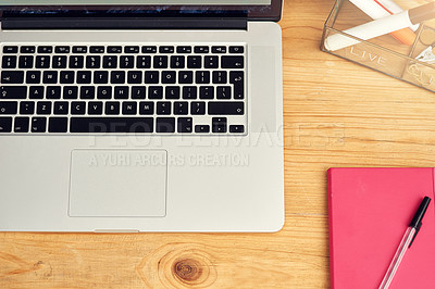 Buy stock photo High angle shot of a laptop and notebook on an office desk