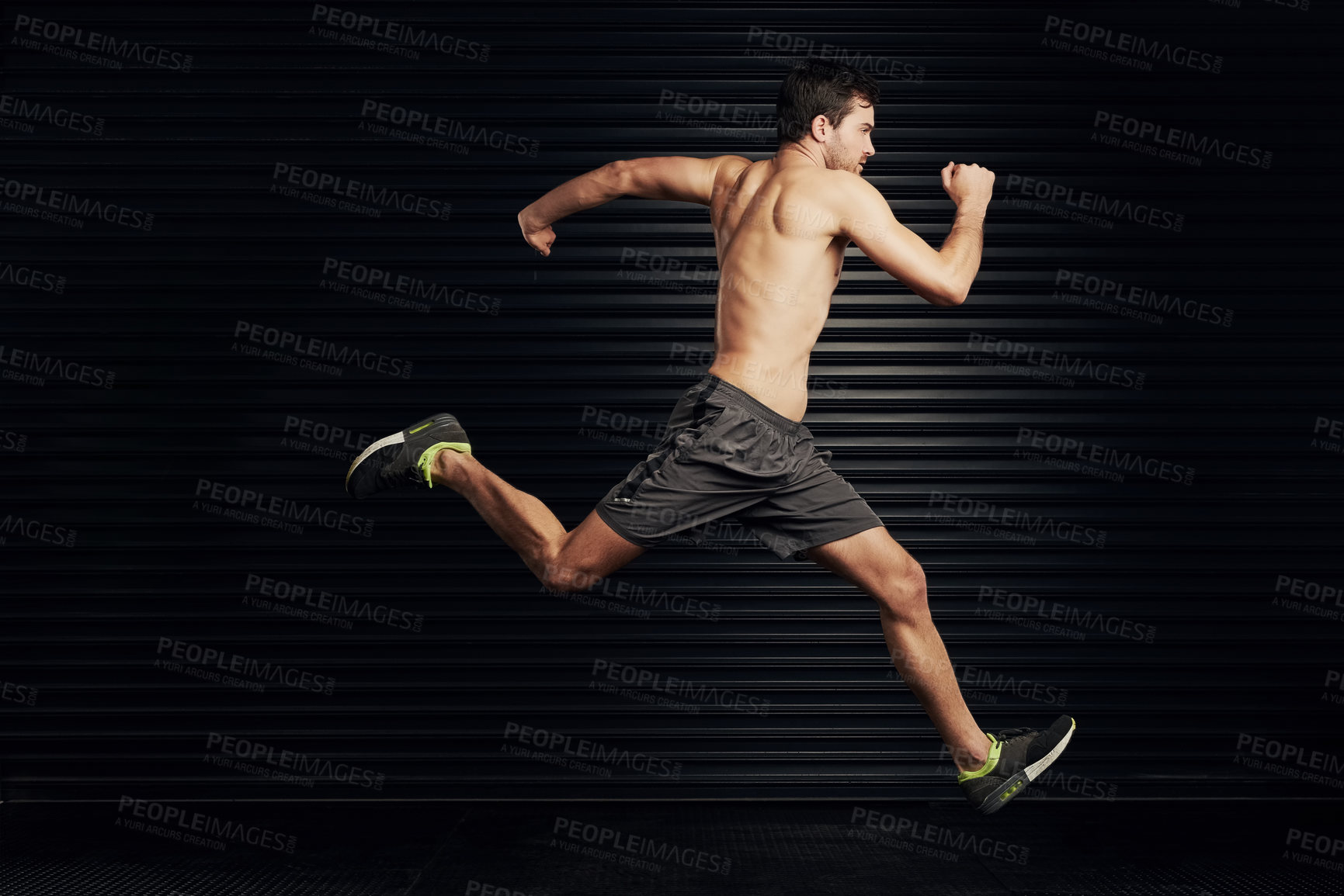 Buy stock photo Running, fitness and man on wall black background for training, exercise and bodybuilder workout. Sports, runner and person in action with strong, muscular body for wellness, health and performance