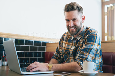 Buy stock photo Portrait of a young man using his laptop while sitting in a cafe