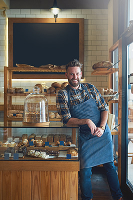 Buy stock photo Portrait of a young business owner standing behind the counter in his bakery