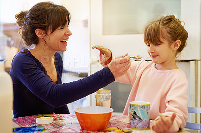 Buy stock photo Happy mother, child and feeding with cereal for fiber, vitamin or breakfast in kitchen together at home. Mom, little girl or young daughter with spoon of porridge for healthy meal, nutrition or snack
