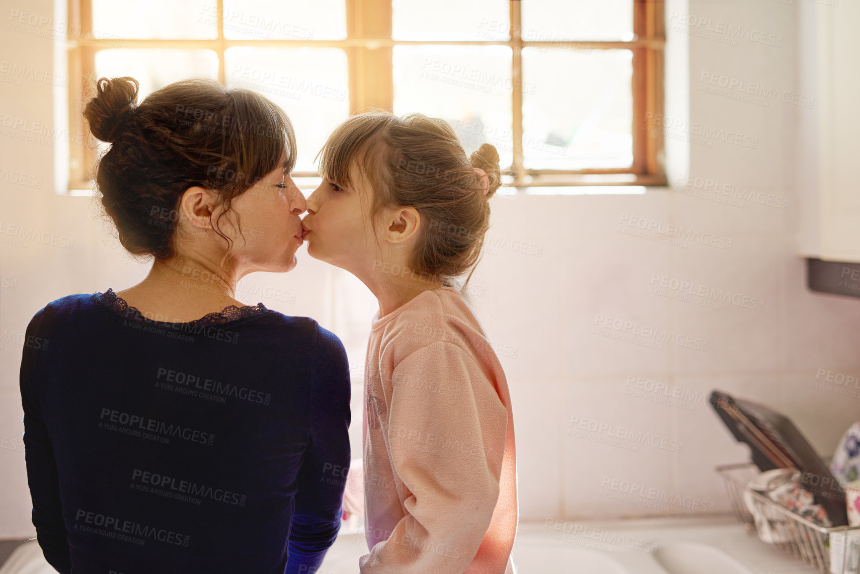 Buy stock photo Kiss, bonding and mother with child in kitchen for housekeeping or cleaning together with learning. Happy, cute and mom with sweet girl kid for love and care with teaching chores at family home.