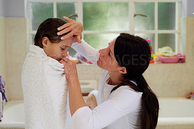 Buy stock photo Cropped shot of a mother feeling the forehead of her sick little girl after a bath