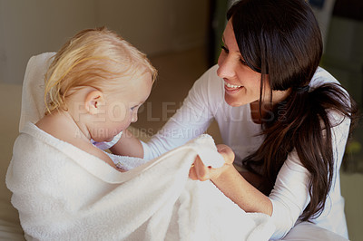 Buy stock photo Cropped shot of a mother drying off her little girl with a towel after her bath