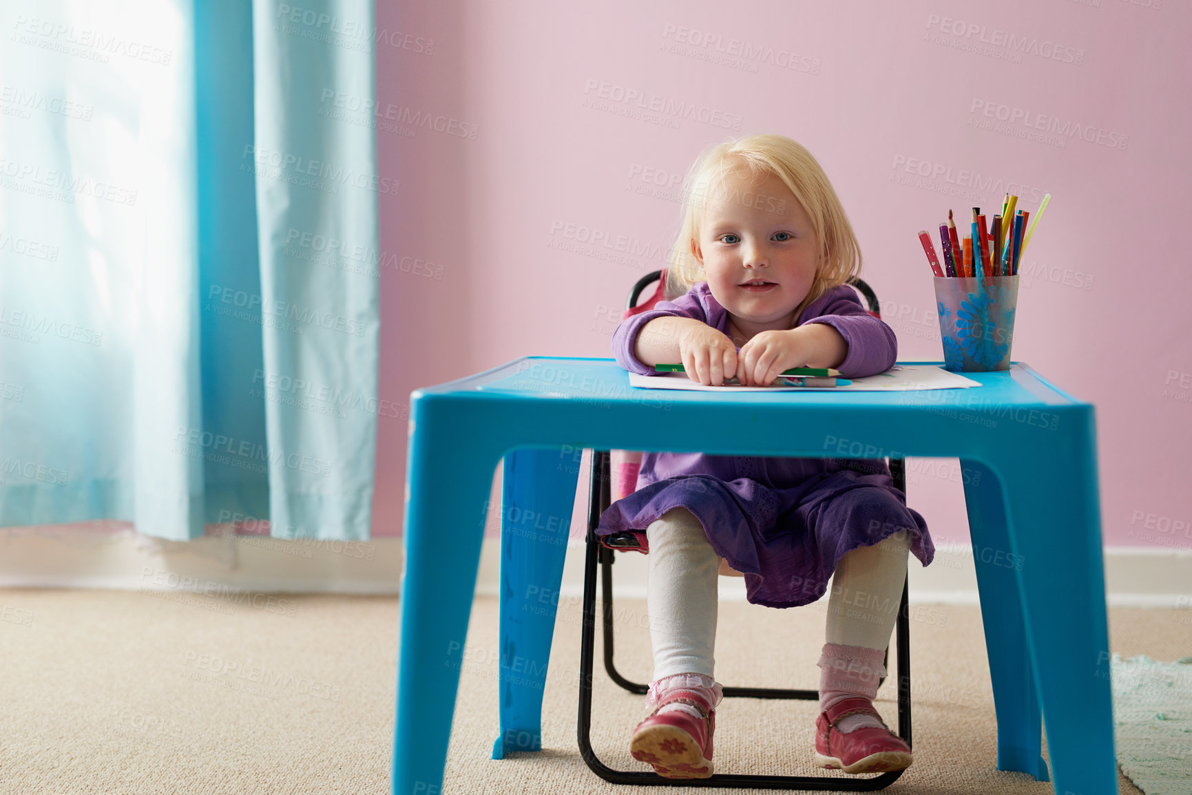 Buy stock photo Portrait of an adorable little girl colouring in at her own small table at home