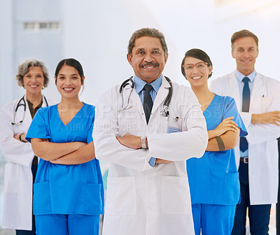 Buy stock photo Portrait of a medical team standing with their arms folded in a hospital