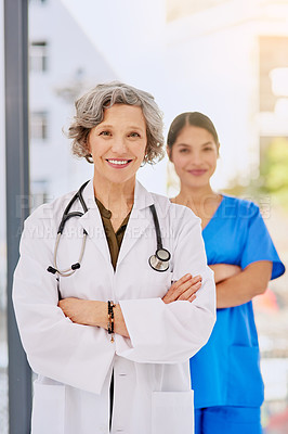 Buy stock photo Portrait of a female doctor standing in front of her inter with both their arms folded
