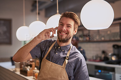 Buy stock photo Man, coffee shop or cafe phone call with smile for contact, deal and beverage order at small business. Happy, barista or waiter on mobile in kitchen for conversation, networking and customer service