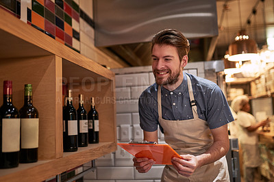 Buy stock photo Man, clipboard and wine on shelf in restaurant for alcohol, inventory and management for hospitality. Male cafe owner, paperwork and sale for small business, pub and entrepreneur in service industry 
