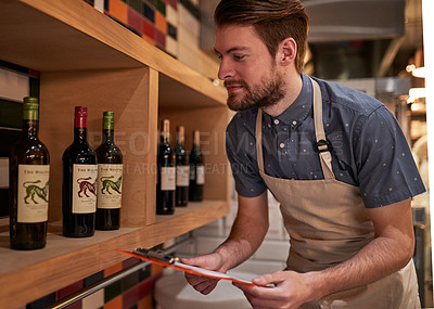 Buy stock photo Man, documents and wine on shelf in restaurant for alcohol, inventory and management for hospitality. Male cafe owner, paperwork and sale for small business, pub and entrepreneur in service industry 