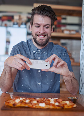 Buy stock photo Man, pizza and cellphone in restaurant for social media, networking and happy in cafe. Male influencer, technology and Italian food at table for nutrients, wellness and dinner in New York bistro
