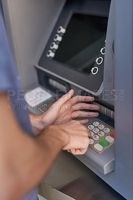 Buy stock photo Cropped shot of a man entering his secret pin code at an ATM