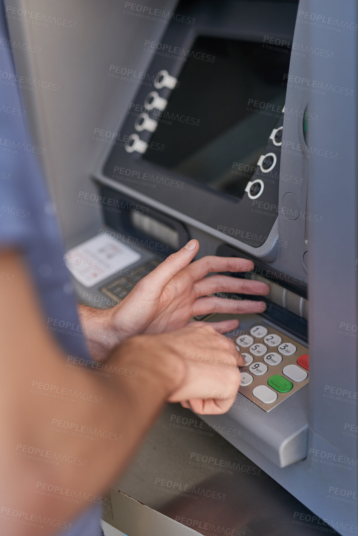 Buy stock photo Cropped shot of a man entering his secret pin code at an ATM