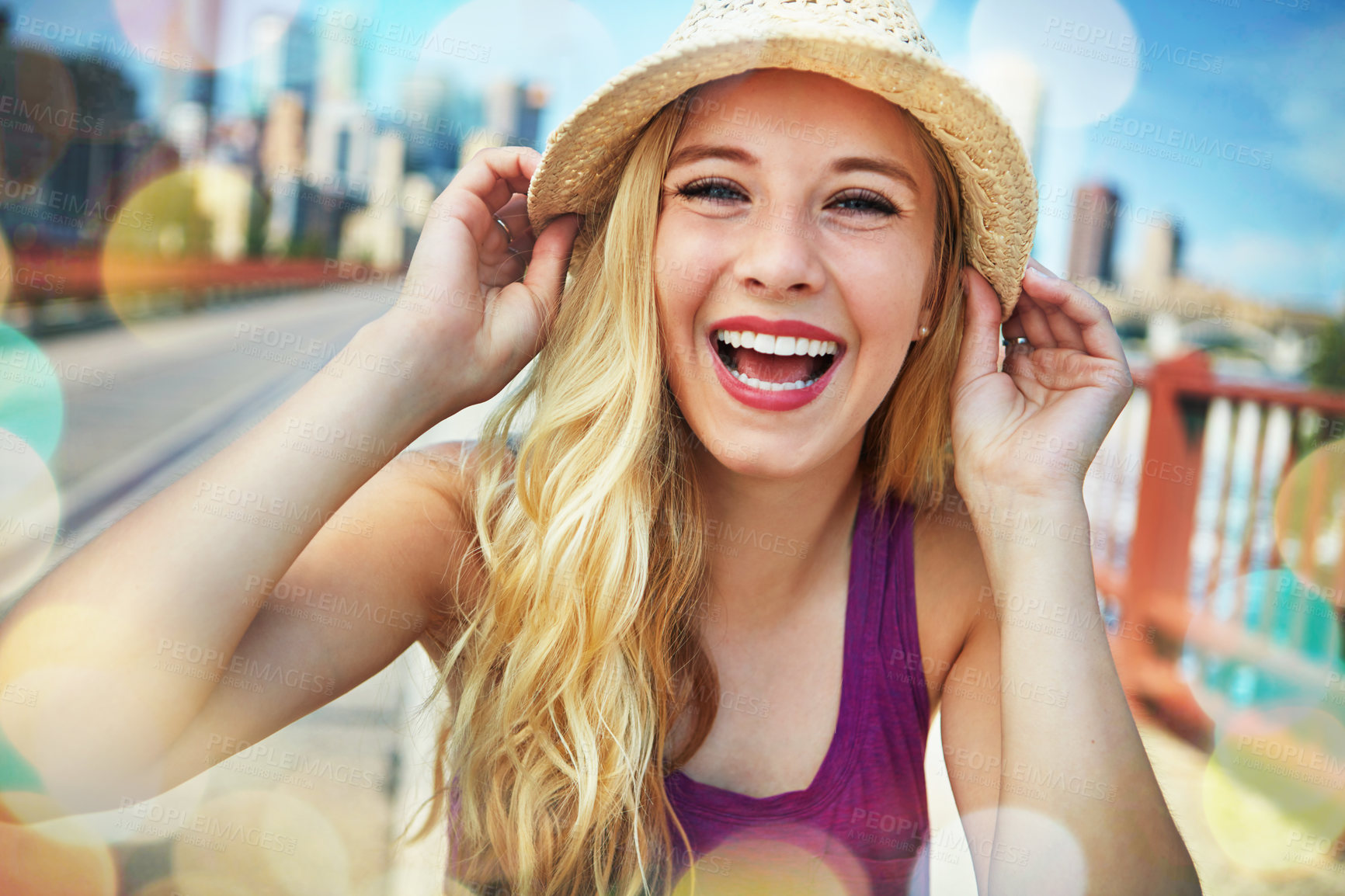 Buy stock photo Shot of a smiling young woman walking around the city in the summertime