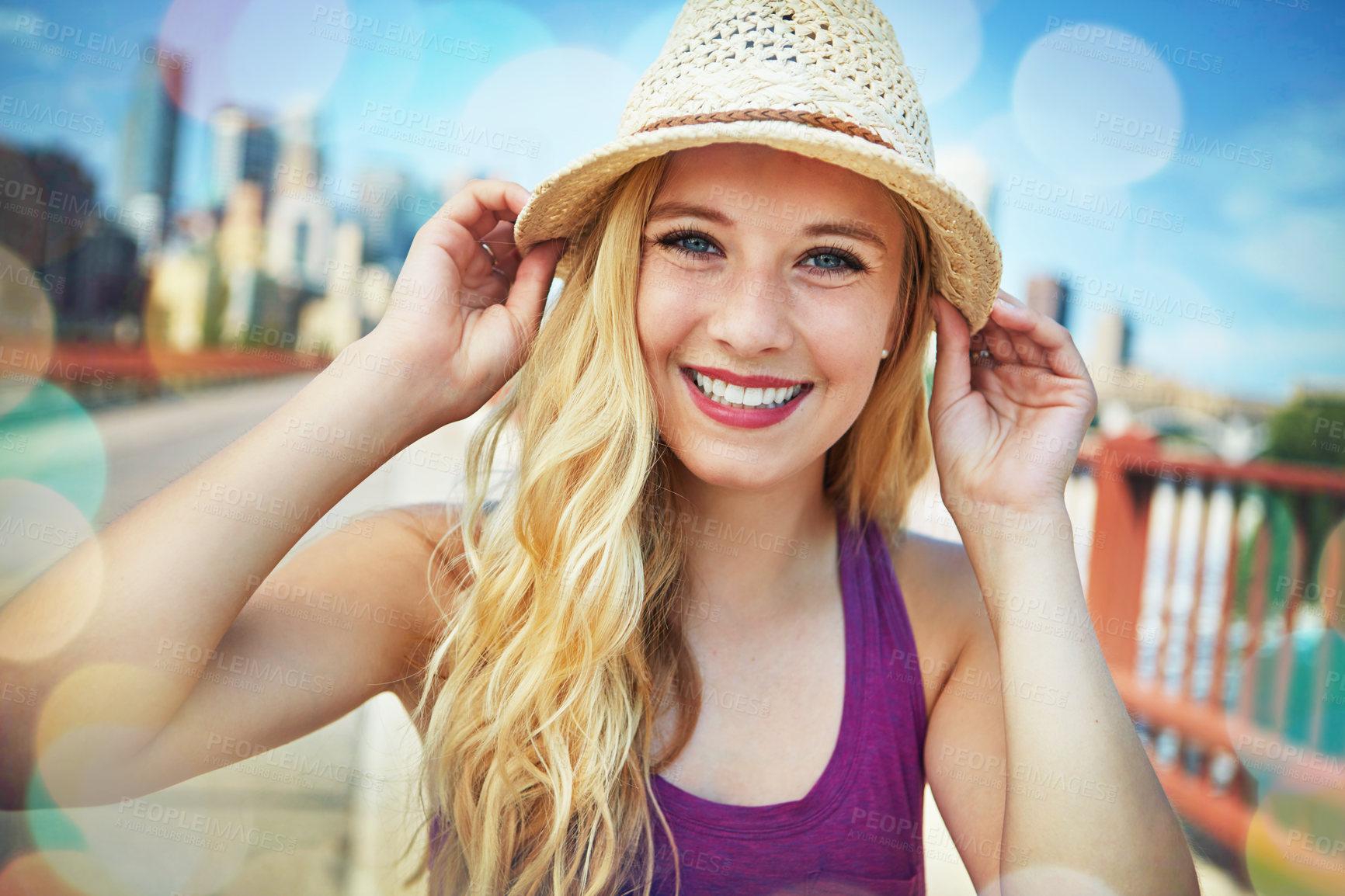 Buy stock photo Shot of a smiling young woman walking around the city in the summertime