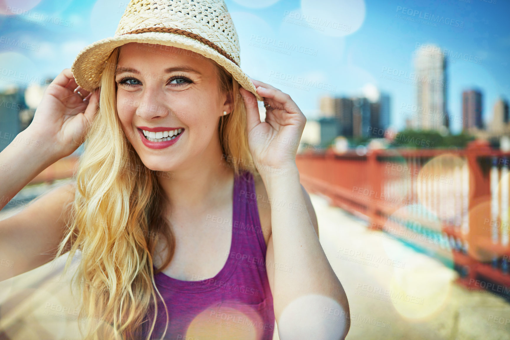 Buy stock photo Shot of a smiling young woman walking around the city in the summertime