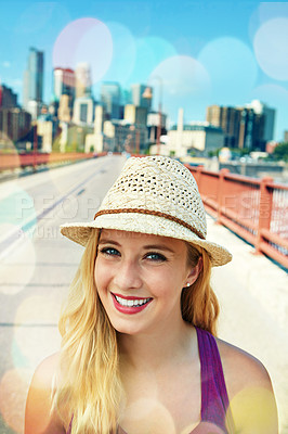 Buy stock photo Shot of a smiling young woman walking around the city in the summertime