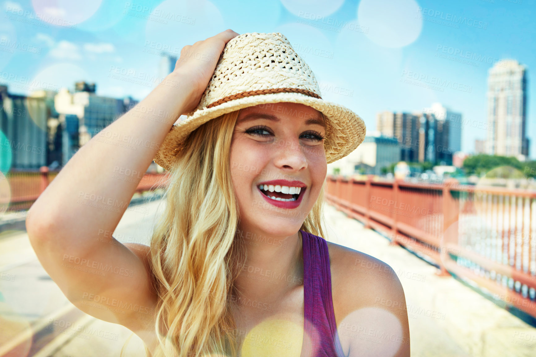 Buy stock photo Shot of a smiling young woman walking around the city in the summertime