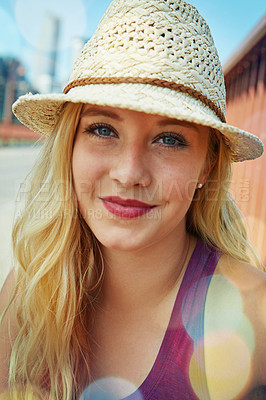 Buy stock photo Shot of a smiling young woman walking around the city in the summertime