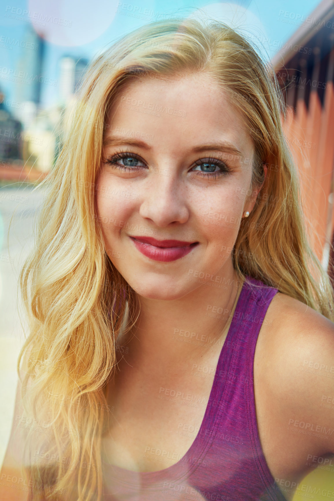 Buy stock photo Shot of a smiling young woman walking around the city in the summertime