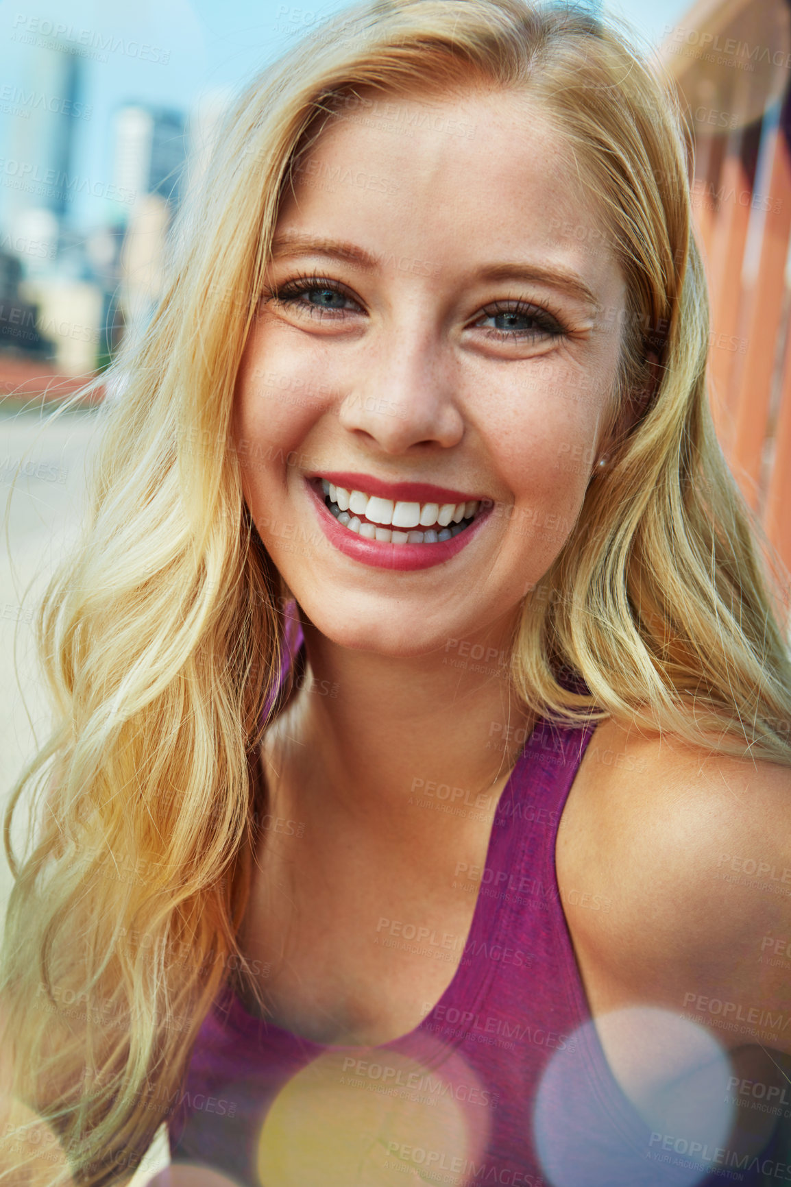 Buy stock photo Shot of a smiling young woman walking around the city in the summertime