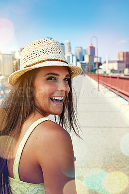 Buy stock photo Shot of a smiling young woman walking around the city in the summertime