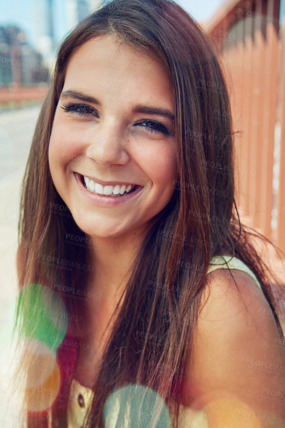 Buy stock photo Shot of a smiling young woman walking around the city in the summertime