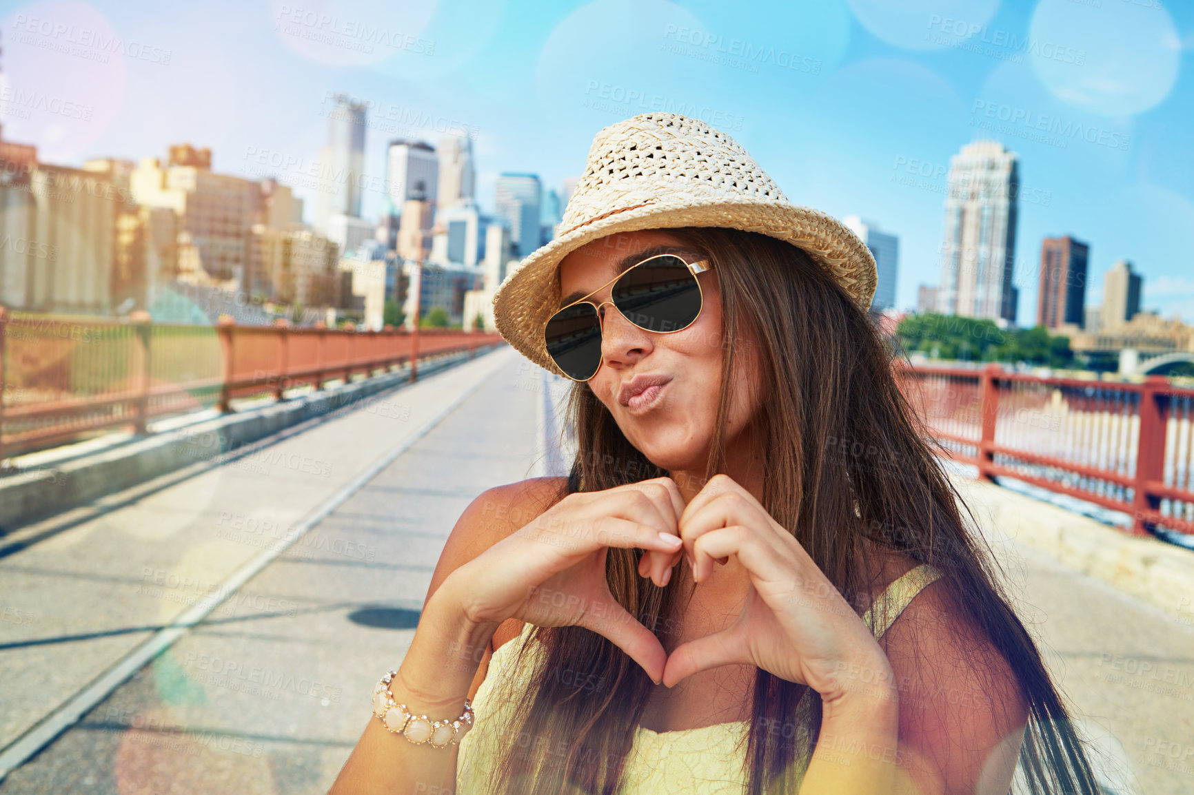 Buy stock photo Shot of a smiling young woman walking around the city in the summertime