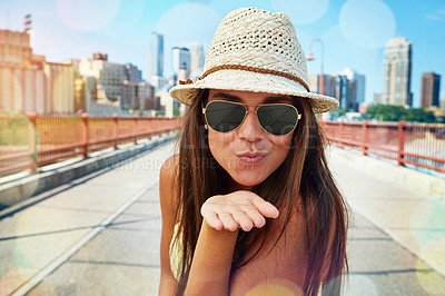 Buy stock photo Shot of a smiling young woman walking around the city in the summertime