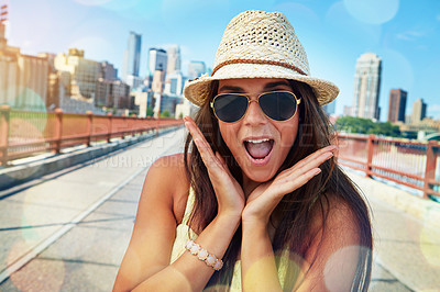 Buy stock photo Shot of a smiling young woman walking around the city in the summertime