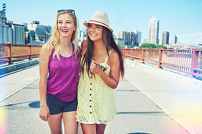 Buy stock photo Shot of best friends having a good time out in the city